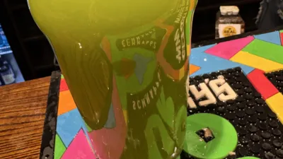 A luminous green pint glass cocktail.